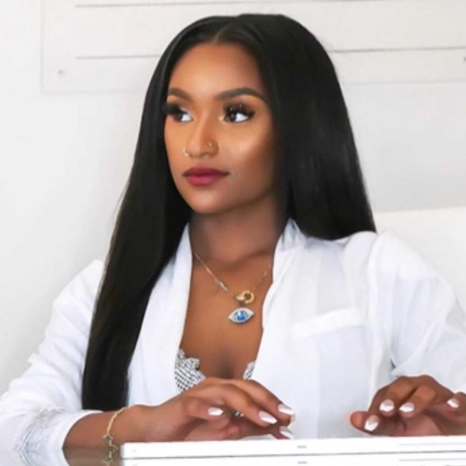 Portrait of Nyya Fletcher, a professional stylist at Cole Stevens Salon, showcasing their expertise and style.