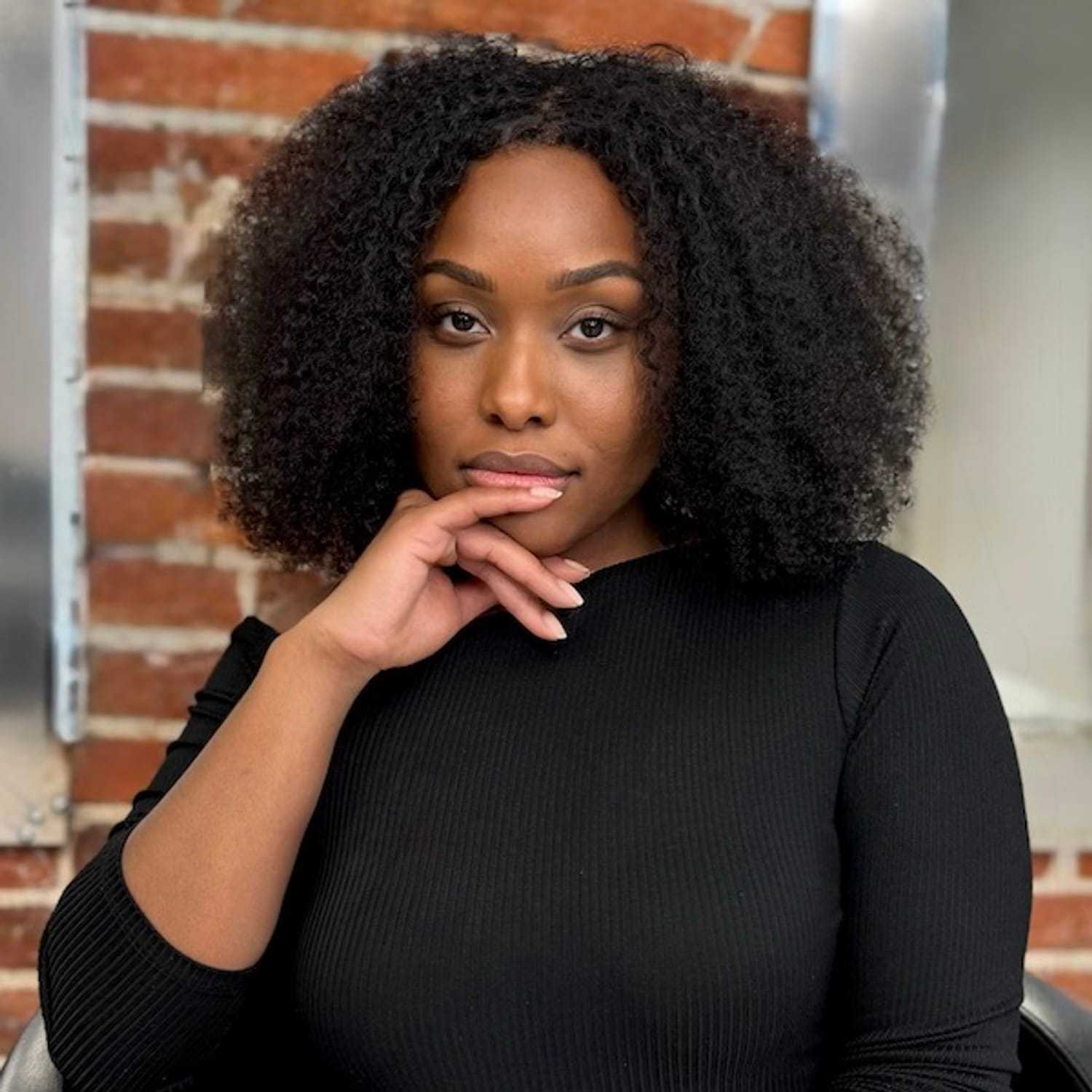 Portrait of Mel Vega, a professional stylist at Cole Stevens Salon, showcasing their expertise and style.